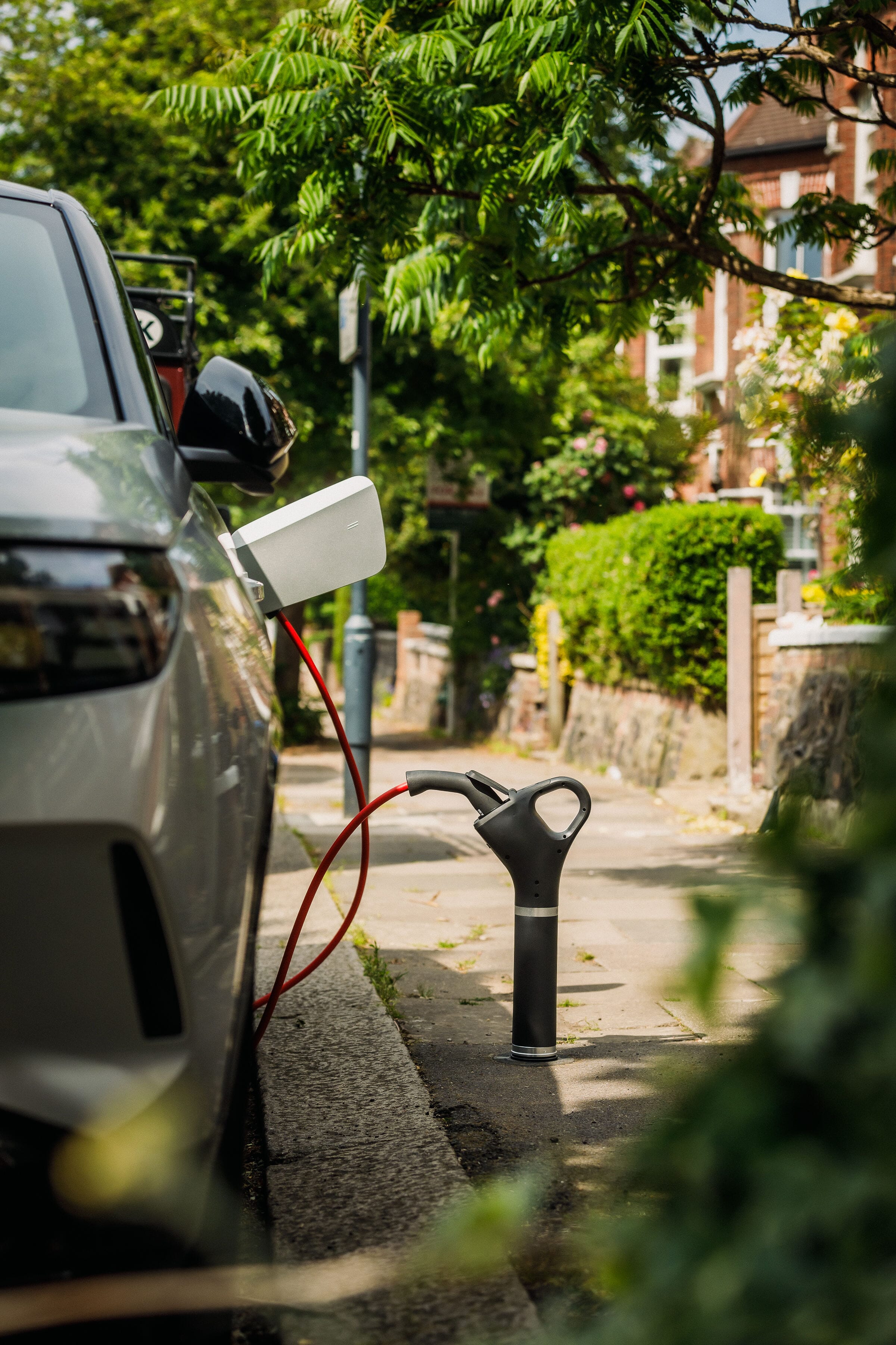 Trojan Energy charge point with adaptor and car charging